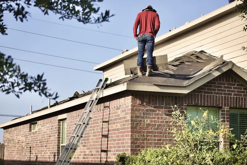 Professional roofer working on a residential roof in Oakmont Manor